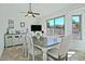Neutral dining area with large windows, designer chairs and tile flooring at 10939 N 111Th St, Scottsdale, AZ 85259
