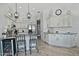 Bright kitchen boasts white cabinetry, granite countertops, stainless appliances, and a convenient breakfast bar at 10939 N 111Th St, Scottsdale, AZ 85259