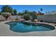 Enjoy a private backyard pool with lush desert landscaping and clear blue skies above at 10939 N 111Th St, Scottsdale, AZ 85259