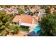 Stunning aerial view showcasing a home with a backyard pool, covered patio, and lush landscaping in a residential neighborhood at 1110 N Gull Haven Ct, Gilbert, AZ 85234