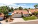 Aerial view of a charming single-Gathering home with a well-manicured lawn, mature trees, and a three-car garage at 1110 N Gull Haven Ct, Gilbert, AZ 85234