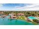 Stunning aerial view of a lakeside home with a sandy beach, boat dock, pool, lush greenery, and a meticulously landscaped yard at 1110 N Gull Haven Ct, Gilbert, AZ 85234