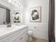 Cozy bathroom showcasing a white vanity with a neutral color scheme and classic fixtures, along with decorative artwork at 1110 N Gull Haven Ct, Gilbert, AZ 85234