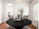 Stylishly decorated dining area with black round table, white flowers, and decor details by window at 1110 N Gull Haven Ct, Gilbert, AZ 85234