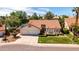 Inviting home with a terracotta roof, a three-car garage, manicured landscaping, and a charming front lawn at 1110 N Gull Haven Ct, Gilbert, AZ 85234
