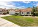 A well-maintained home showcasing traditional Southwestern architecture, lush landscaping, and a vibrant green lawn at 1110 N Gull Haven Ct, Gilbert, AZ 85234