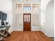 Bright foyer featuring hardwood floors, a striking front door, and modern decor at 1110 N Gull Haven Ct, Gilbert, AZ 85234