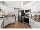 Modern kitchen with granite countertops and stainless steel appliances with view to dining room at 1110 N Gull Haven Ct, Gilbert, AZ 85234