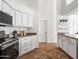 Well-lit kitchen featuring white cabinets, granite countertops, and modern stainless steel appliances at 1110 N Gull Haven Ct, Gilbert, AZ 85234