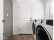 Clean laundry room featuring modern washer and dryer units and a white door at 1110 N Gull Haven Ct, Gilbert, AZ 85234