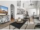 Bright living room featuring tile floors, a modern black coffee table, and open access to the kitchen at 1110 N Gull Haven Ct, Gilbert, AZ 85234