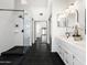 Modern main bathroom featuring a walk-in shower, double vanity, and dark tile floors at 1110 N Gull Haven Ct, Gilbert, AZ 85234