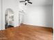 Large main bedroom with wood floors, ceiling fan, and en-suite bathroom access at 1110 N Gull Haven Ct, Gilbert, AZ 85234