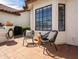 A cozy outdoor patio featuring a tiled floor, stylish seating, potted plants, and a tranquil atmosphere at 1110 N Gull Haven Ct, Gilbert, AZ 85234