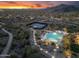 Expansive aerial view showcasing community pool, tennis courts, and walking path at sunset at 11339 E Beck Ln, Scottsdale, AZ 85255