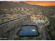 Stunning aerial view of the community highlighting desert landscape, pool, and tennis courts at 11339 E Beck Ln, Scottsdale, AZ 85255