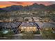 Aerial shot of backyard oasis with pool, spa, covered patio, and lush landscaping at 11339 E Beck Ln, Scottsdale, AZ 85255