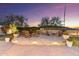 Elevated backyard patio area features outdoor seating perfect for relaxing or entertaining with beautiful landscaping at 11339 E Beck Ln, Scottsdale, AZ 85255