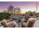 Backyard patio showcasing seating around a table and fountain, all surrounded by mature trees and desert landscaping at 11339 E Beck Ln, Scottsdale, AZ 85255