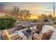 This backyard features a seating area with comfortable chairs and a peaceful fountain with beautiful desert views at 11339 E Beck Ln, Scottsdale, AZ 85255