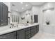 Elegant bathroom with dual sinks, framed mirrors, decorative niches, and neutral color palette at 11339 E Beck Ln, Scottsdale, AZ 85255
