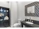 Stylish powder room features elegant mirror, toilet and vanity sink at 11339 E Beck Ln, Scottsdale, AZ 85255