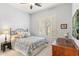 Cozy bedroom with iron bed frame, soft blue accents and plantation shutters at 11339 E Beck Ln, Scottsdale, AZ 85255