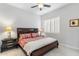 Bedroom features king-sized bed, side tables, and plantation shutters at 11339 E Beck Ln, Scottsdale, AZ 85255