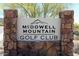 McDowell Mountain Golf Club sign surrounded by a stone facade and desert landscaping at 11339 E Beck Ln, Scottsdale, AZ 85255