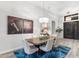 Elegant dining room featuring wood table, upholstered chairs, and a stylish chandelier at 11339 E Beck Ln, Scottsdale, AZ 85255