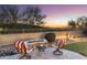 This home has a lovely outdoor fire pit with comfortable seating that provides a cozy atmosphere for relaxing and enjoying desert views at 11339 E Beck Ln, Scottsdale, AZ 85255
