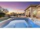 Relaxing hot tub with built in lights overlooking the patio with lovely sunset views and an outdoor kitchen at 11339 E Beck Ln, Scottsdale, AZ 85255