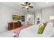Bright main bedroom showcases a ceiling fan, stylish dresser, and doorway to the en-suite bathroom at 11339 E Beck Ln, Scottsdale, AZ 85255