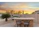 Outdoor bar area with stone accents, seating and built in BBQ for cooking while enjoying the desert landscape at 11339 E Beck Ln, Scottsdale, AZ 85255