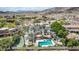 Aerial view of luxury home showcasing a pool and landscaped grounds in a desert setting at 11827 S Montezuma Ct, Phoenix, AZ 85044