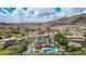 Expansive view of a luxury home with a pool, set against a mountain backdrop at 11827 S Montezuma Ct, Phoenix, AZ 85044