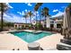 A large backyard with a pool, lounge area, and palm trees makes for ultimate outdoor living at 11827 S Montezuma Ct, Phoenix, AZ 85044