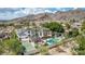 Backyard with a pool, spa, tennis court, and covered patio, providing a private outdoor retreat at 11827 S Montezuma Ct, Phoenix, AZ 85044