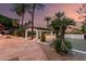 Beautiful backyard featuring a patio cover, palm trees, and tennis court at 11827 S Montezuma Ct, Phoenix, AZ 85044