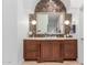 Bathroom vanity featuring warm wood cabinetry and marble accents at 11827 S Montezuma Ct, Phoenix, AZ 85044