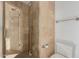 Bathroom featuring a shower with a glass door and a tiled wall at 11827 S Montezuma Ct, Phoenix, AZ 85044