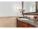 Bathroom vanity with granite counters, wood cabinets, and bronze faucet at 11827 S Montezuma Ct, Phoenix, AZ 85044