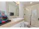 Bathroom with a sleek vanity, beige countertops, and a modern glass-enclosed shower at 11827 S Montezuma Ct, Phoenix, AZ 85044