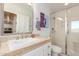 Bathroom with tiled countertop vanity, glass shower, and a door to an adjacent bedroom suite at 11827 S Montezuma Ct, Phoenix, AZ 85044