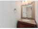 Bathroom featuring a wood cabinet sink with granite countertop and a decorative mirror at 11827 S Montezuma Ct, Phoenix, AZ 85044