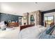 Spacious bedroom with stone wall accent and bed, connecting to a landing area upstairs at 11827 S Montezuma Ct, Phoenix, AZ 85044