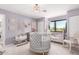 Bedroom with neutral walls, white furniture, with a crib and natural light from the large window at 11827 S Montezuma Ct, Phoenix, AZ 85044