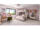 Pink bedroom featuring a desk, bunk bed, and a large window offering an outdoor view at 11827 S Montezuma Ct, Phoenix, AZ 85044