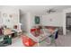 Bonus room with glass table, chairs, sofa, and decorated with wall art at 11827 S Montezuma Ct, Phoenix, AZ 85044