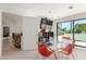 Bright bonus room features a glass dining table, and exterior view with a wall-mounted tv at 11827 S Montezuma Ct, Phoenix, AZ 85044
